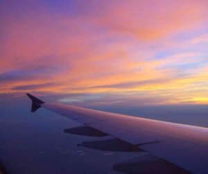 The view from a plane window at sunset