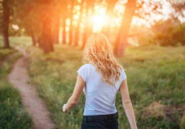 A woman walks in the woods